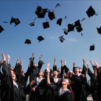 Students throwing their hats at graduation